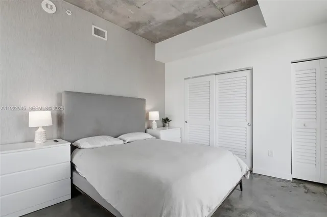 a bedroom with a bed and a night stand