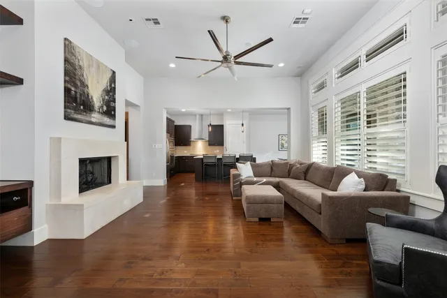 a living room with furniture large window and a fireplace