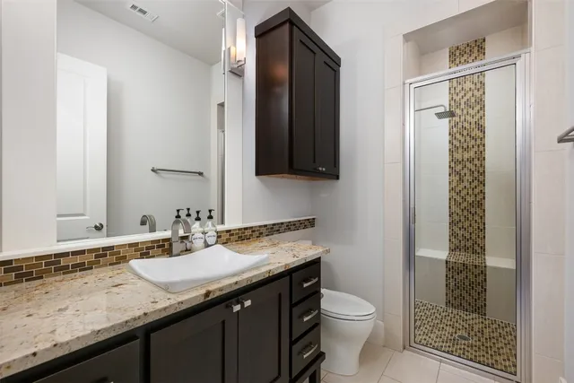 a spacious bedroom with a bed and wooden floor