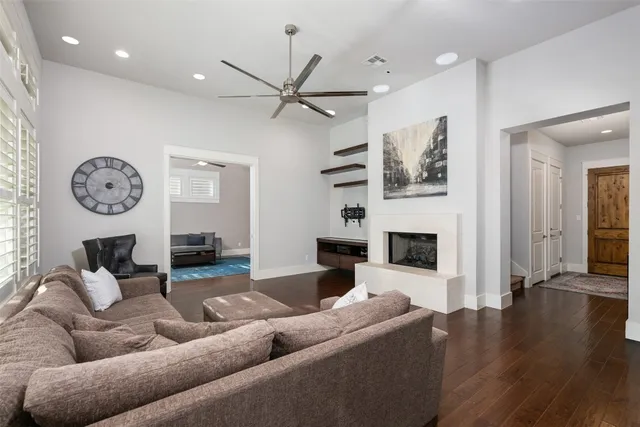a living room with fireplace furniture and a large window