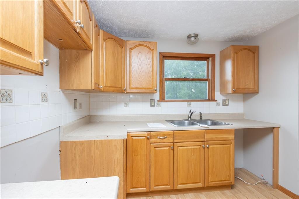 634 Bairdford Road Gibsonia, PA 15044 - Photo 11 of 23 a kitchen with a sink cabinets and window