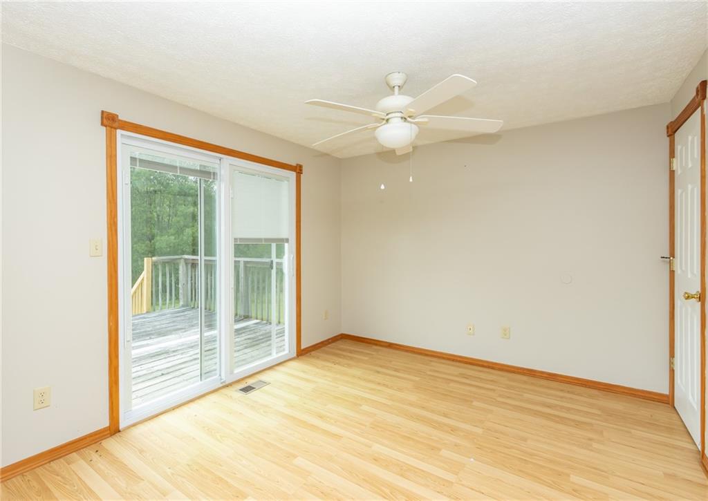 634 Bairdford Road Gibsonia, PA 15044 - Photo 12 of 23 an empty room with wooden floor and windows