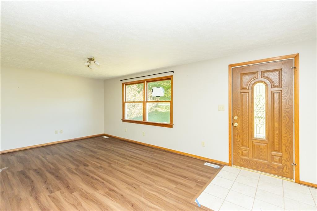 634 Bairdford Road Gibsonia, PA 15044 - Photo 8 of 23 an empty room with wooden floor and windows