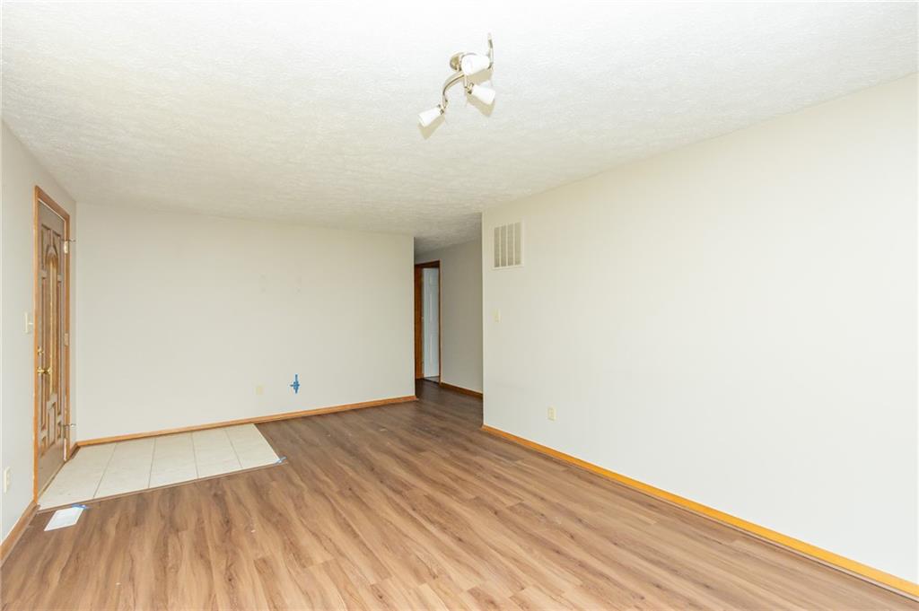 634 Bairdford Road Gibsonia, PA 15044 - Photo 9 of 23 a view of a room with wooden floor and white walls