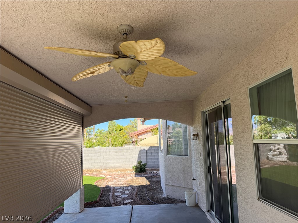 141 Rancho Maria Street Las Vegas, NV 89148 - Photo 23 of 30 An arched opening frames views of the backyard from this sheltered concrete patio.