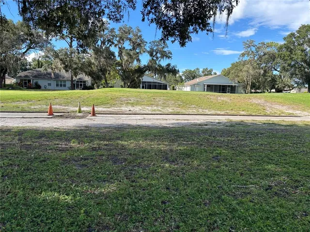 a front view of a house with a garden and trees