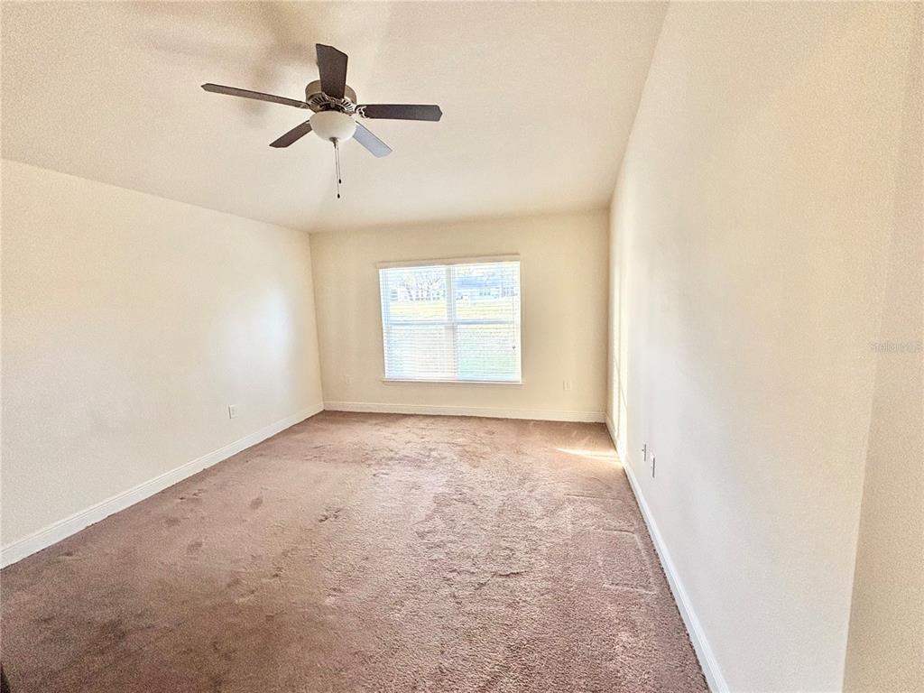 13231 Precept Way Hudson, FL 34669 - Photo 18 of 30 an empty room with a window and a fan