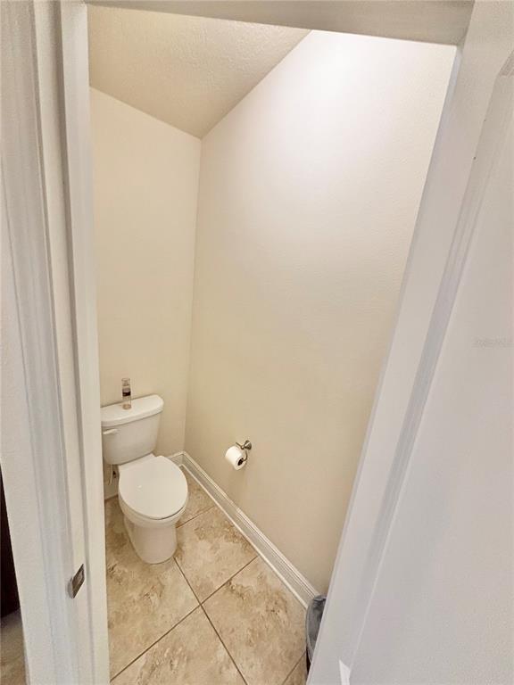 13231 Precept Way Hudson, FL 34669 - Photo 21 of 30 a bathroom with a toilet and a shower