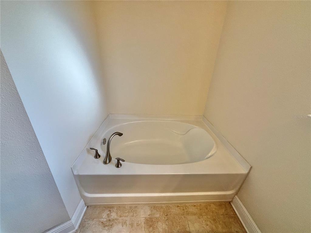 13231 Precept Way Hudson, FL 34669 - Photo 22 of 30 a bathroom with a tub