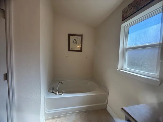 a white bath tub sitting next to a window