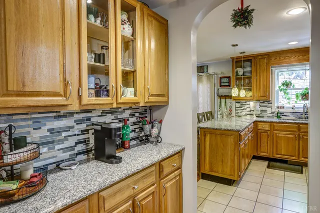 a kitchen with stainless steel appliances granite countertop a sink a stove and a granite counter tops with wooden floors