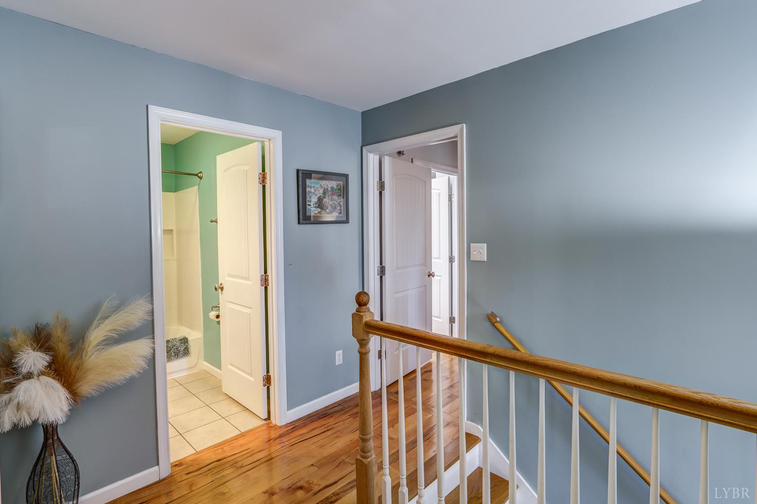 2487 Cifax Road Goode, VA 24556 - Photo 21 of 71 a view of a hallway with wooden floor and stairs