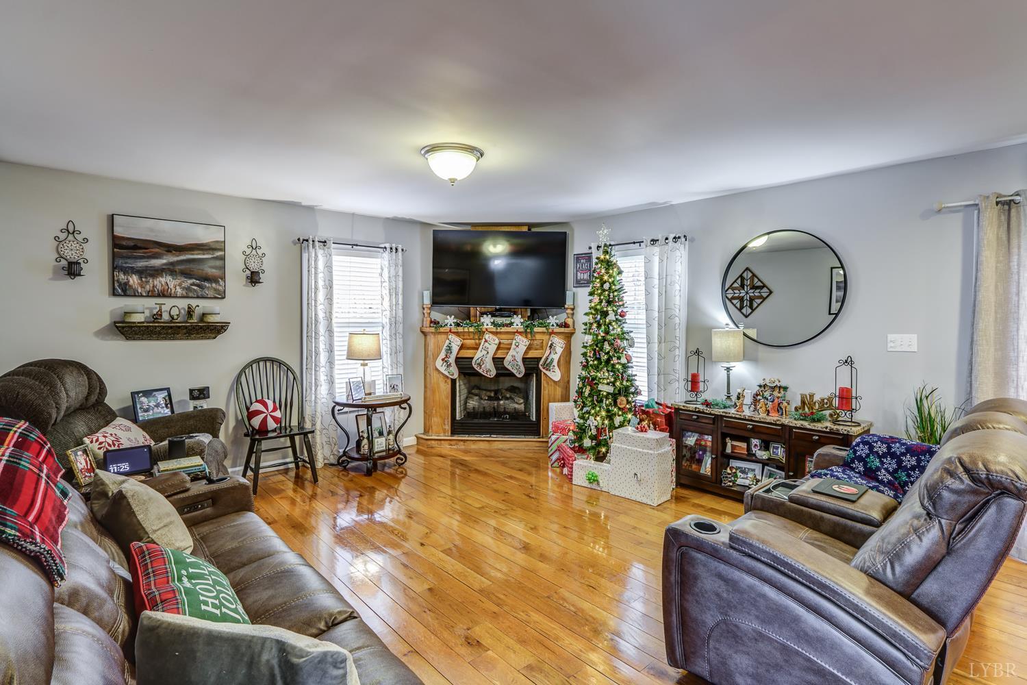 2487 Cifax Road Goode, VA 24556 - Photo 22 of 67 a living room filled with furniture a window and a clock