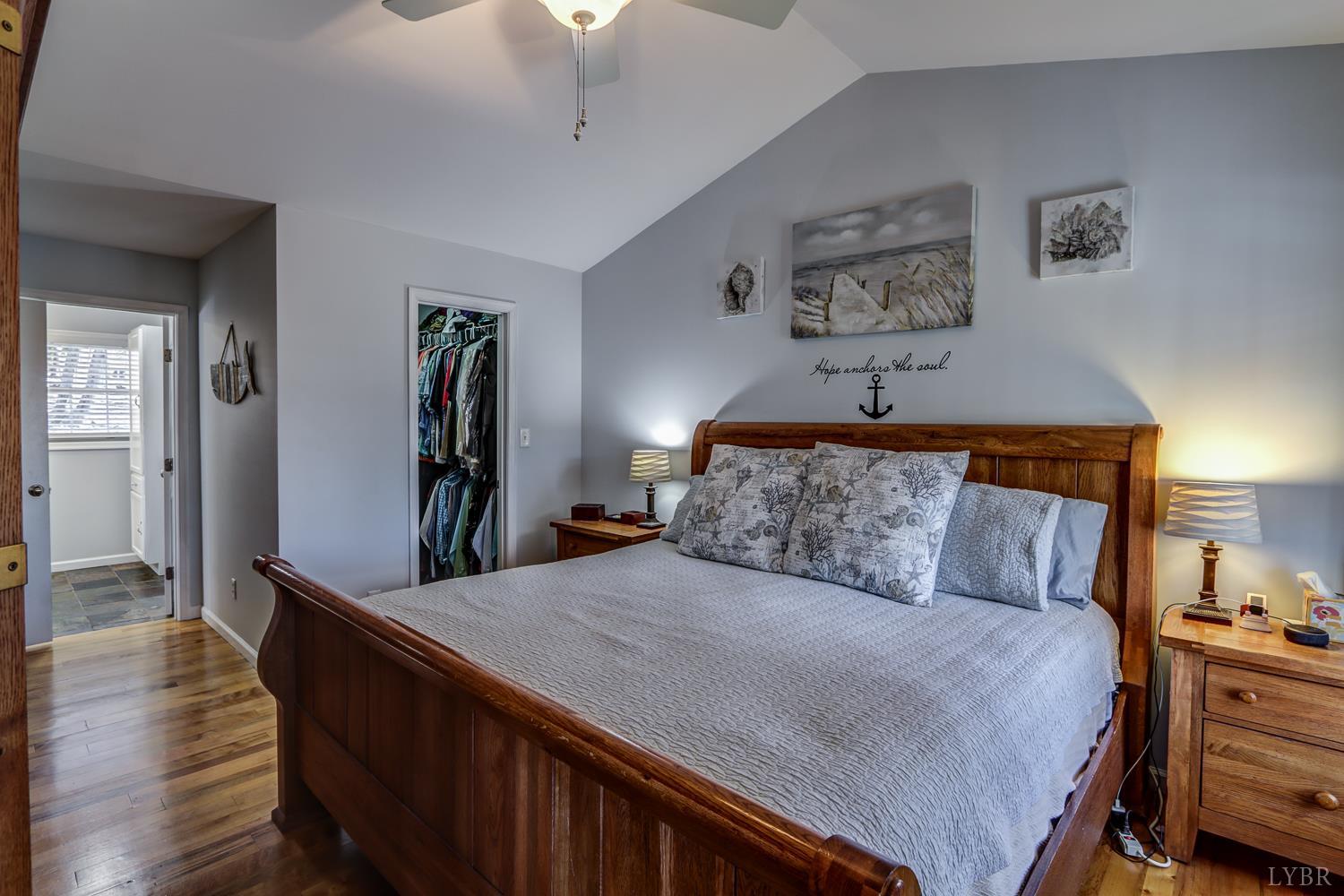 2487 Cifax Road Goode, VA 24556 - Photo 23 of 71 a bedroom with a large bed and a wooden floor