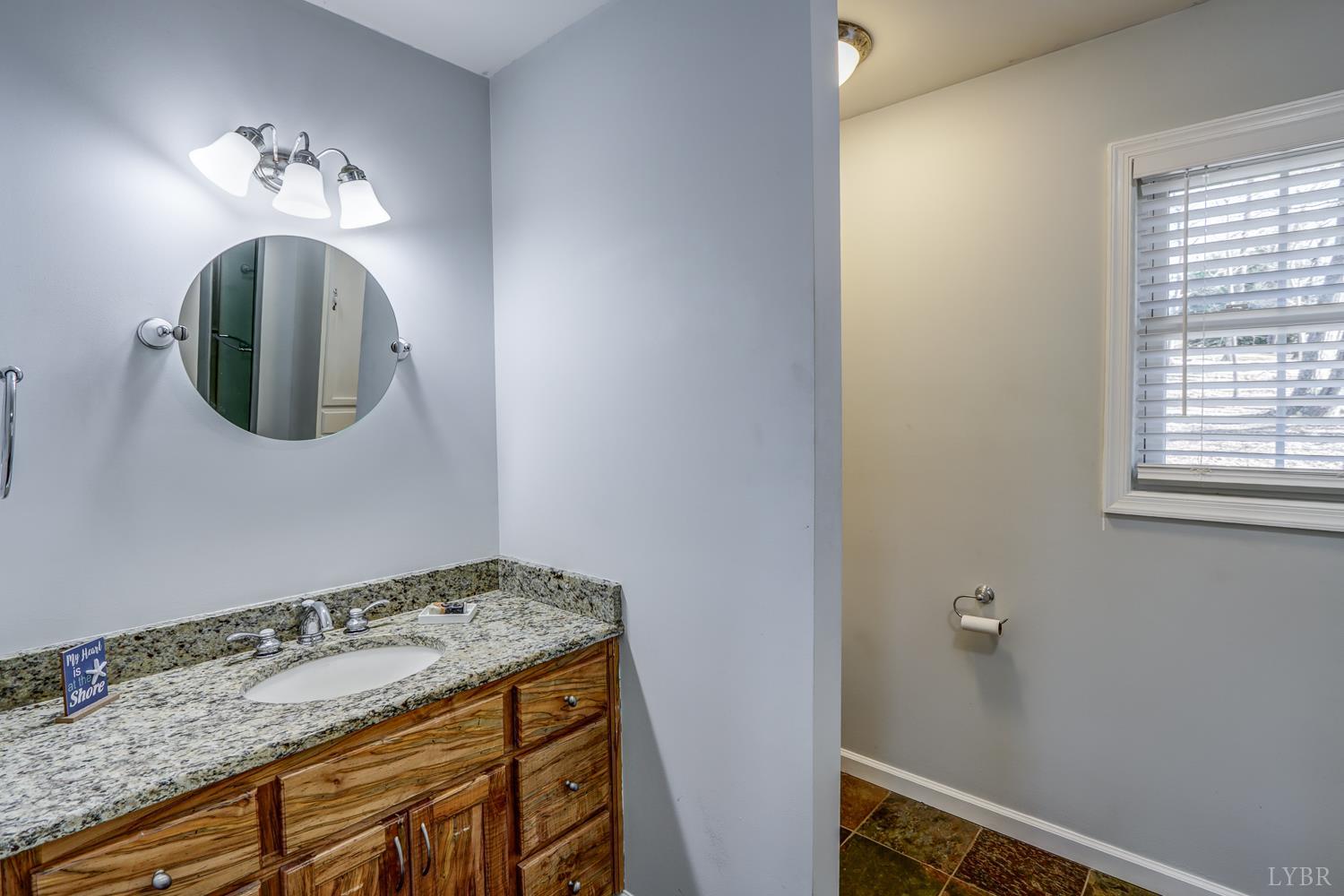 2487 Cifax Road Goode, VA 24556 - Photo 24 of 71 a bathroom with a sink and a mirror