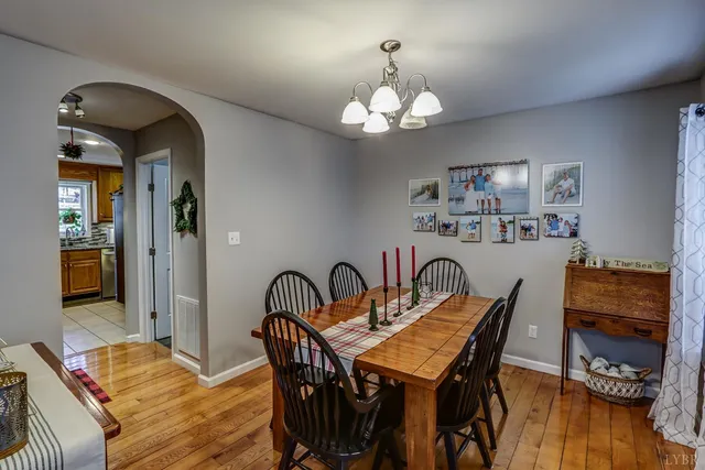 a kitchen with stainless steel appliances granite countertop a stove a sink and a dining table view