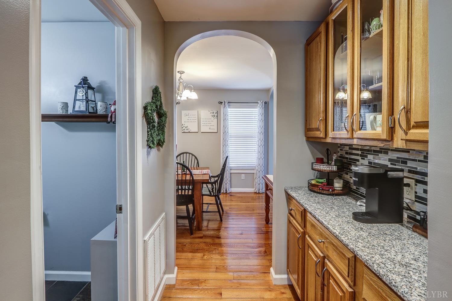 2487 Cifax Road Goode, VA 24556 - Photo 10 of 67 a kitchen with stainless steel appliances granite countertop a stove a sink and a dining table view