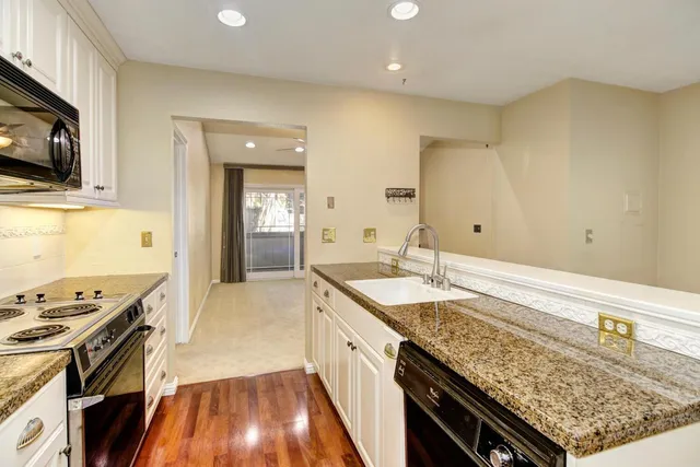 a spacious bathroom with a granite countertop sink and a mirror
