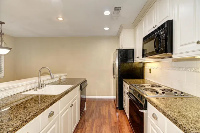 a kitchen with a sink stove and refrigerator