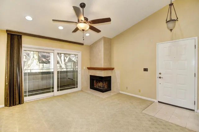 a view of an empty room with a fireplace