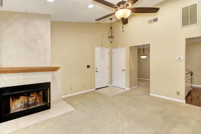 a view of an empty room with a fireplace