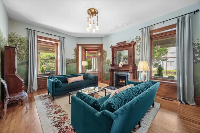 a dining room with furniture a rug and wooden floor