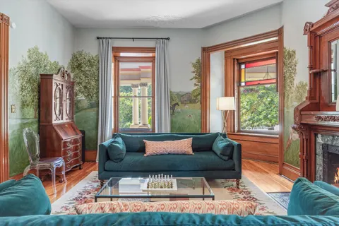 a open kitchen with stainless steel appliances granite countertop a refrigerator a sink dishwasher a stove and a dining table with wooden floor