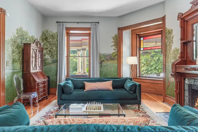 a open kitchen with stainless steel appliances granite countertop a refrigerator a sink dishwasher a stove and a dining table with wooden floor