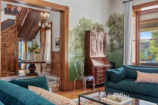 a kitchen with stainless steel appliances granite countertop a refrigerator a stove a sink dishwasher a dining table and chairs with wooden floor