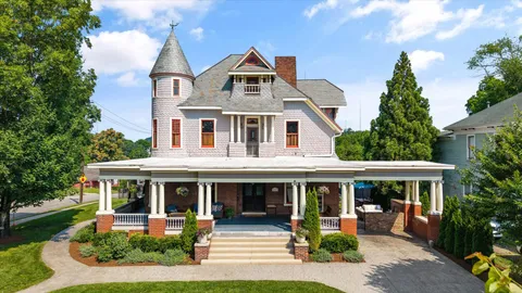 a front view of a house with a yard and trees