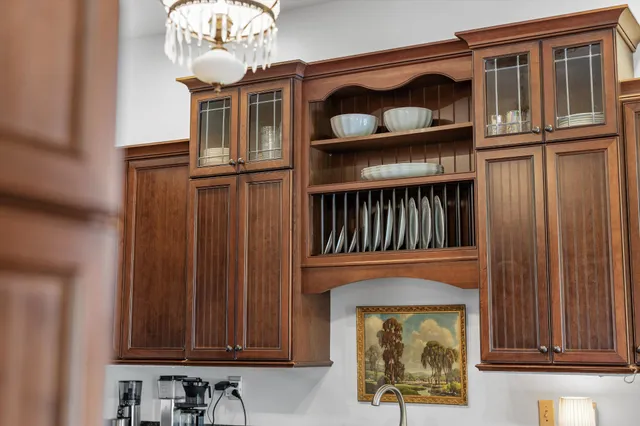 a view of a patio with couches table and chairs under an umbrella with a barbeque