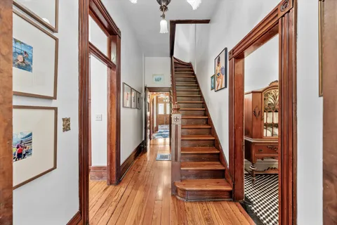 a front view of a house with a yard and potted plants
