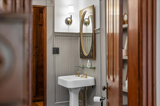 an aerial view of a house with a garden and lake view