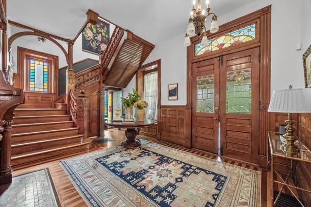 a spacious bedroom with a bed a couch and a chandelier