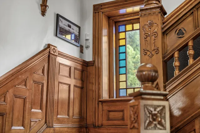 a spacious bedroom with a bed a couch and a chandelier