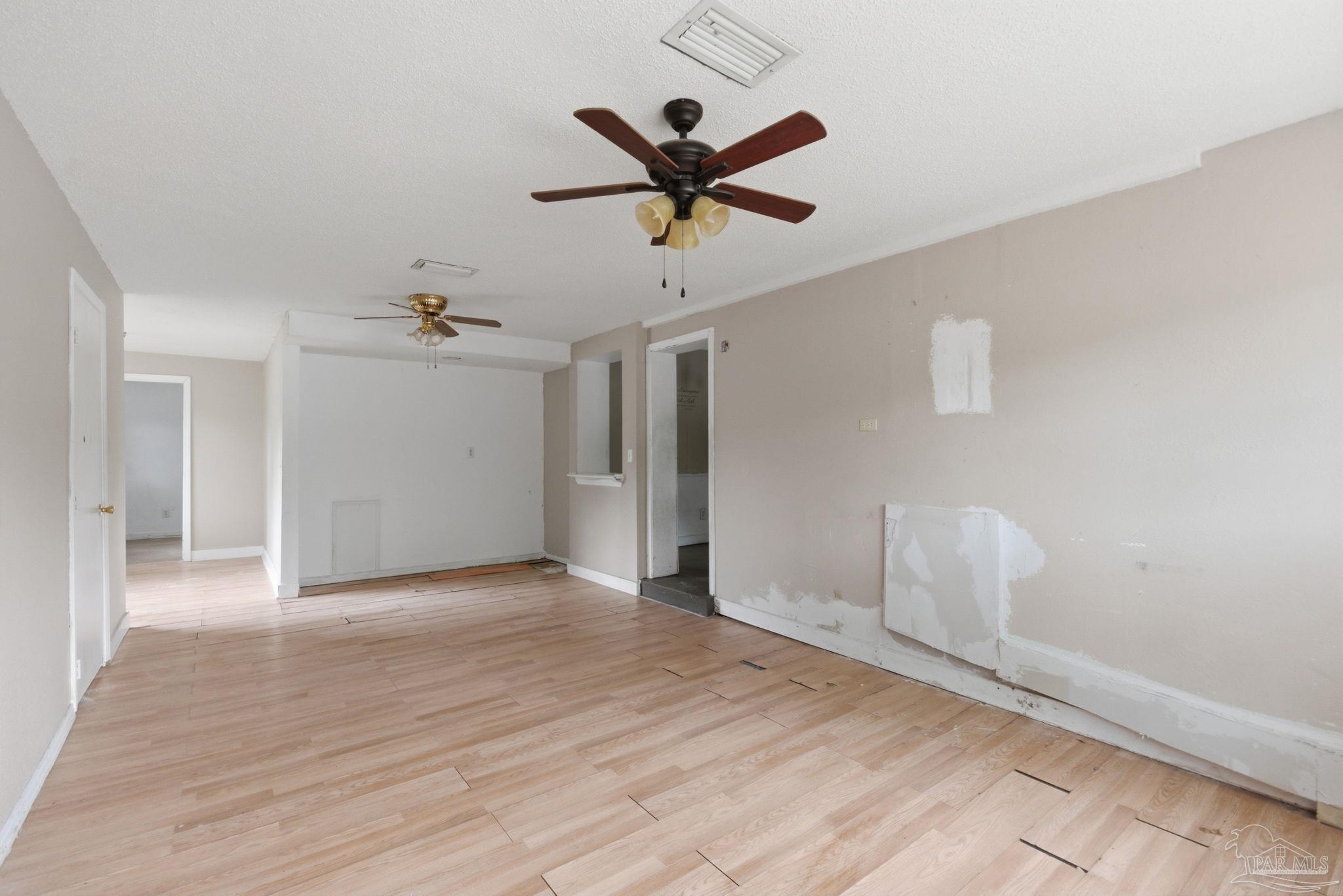 4482 Rochelle Drive Pensacola, FL 32505 - Photo 9 of 30 a view of a livingroom with a ceiling fan and wooden floor