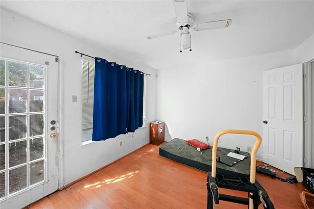 a bedroom with a bed and wooden floor