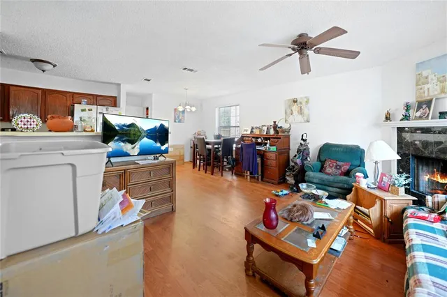 a living room with furniture and a chandelier
