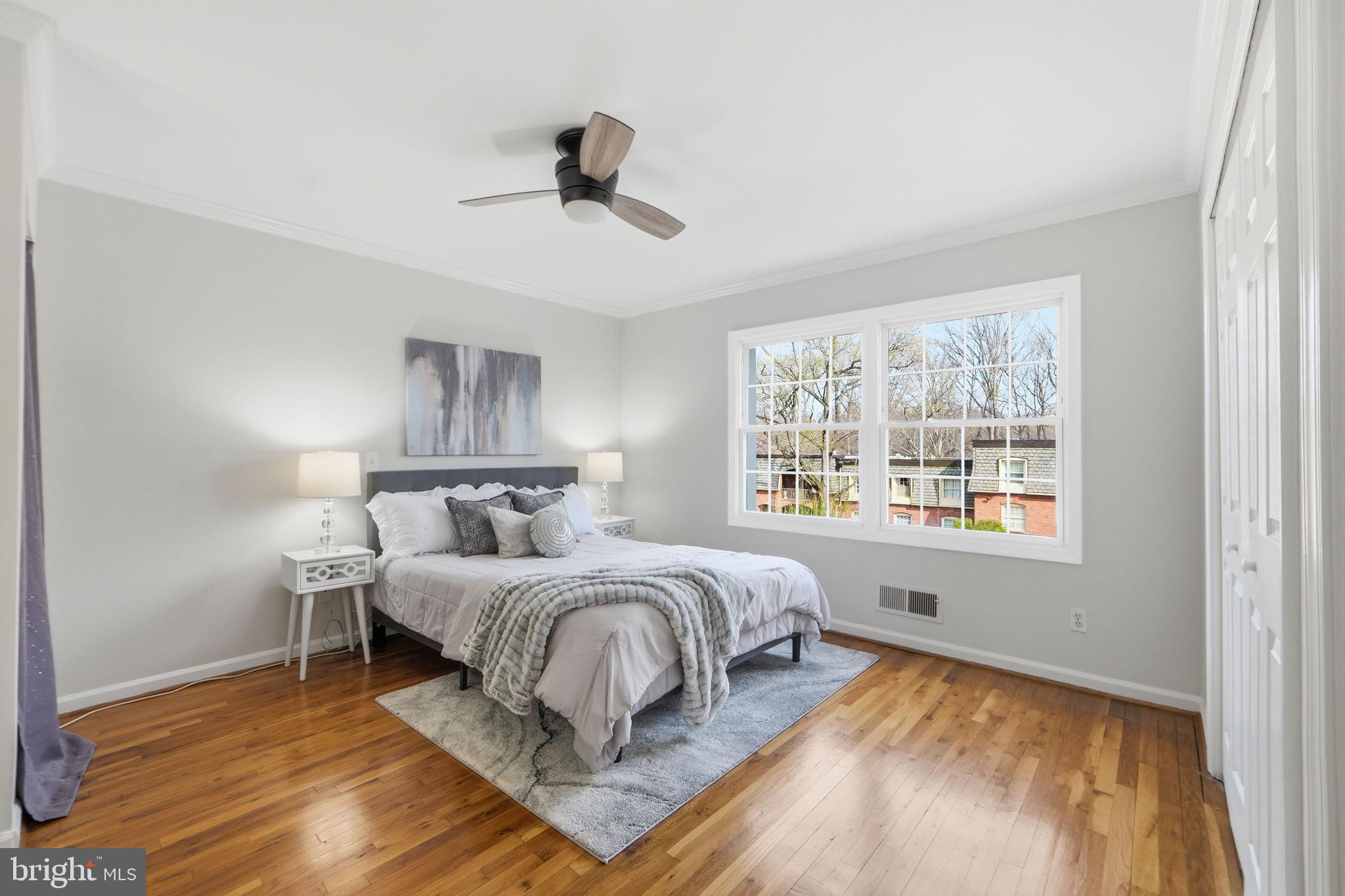 8230 Carrleigh Parkway, Unit 84 Springfield, VA 22152 - Photo 14 of 28 a bedroom with a large bed and a window