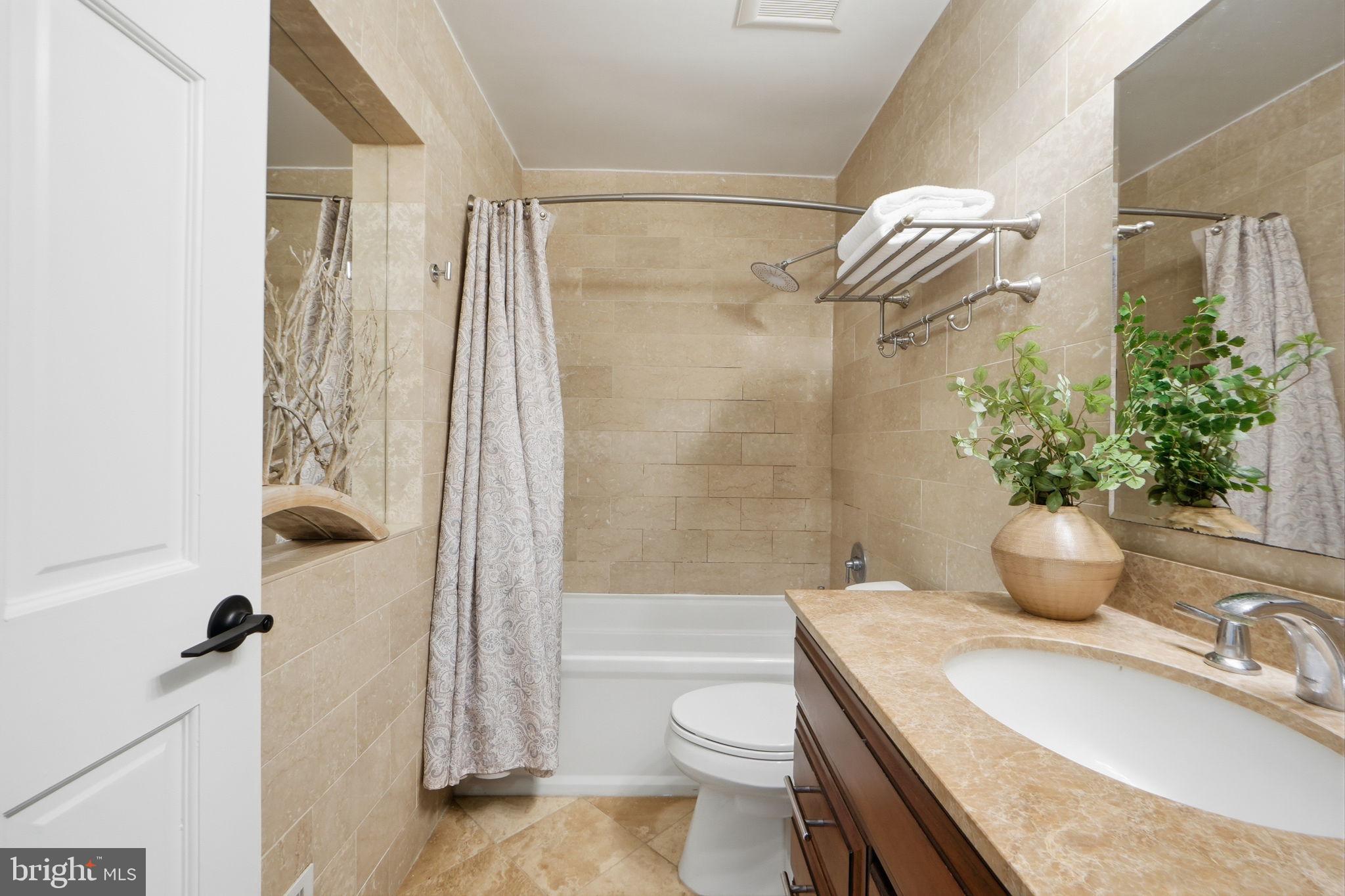 8230 Carrleigh Parkway, Unit 84 Springfield, VA 22152 - Photo 18 of 28 a bathroom with a sink toilet and shower