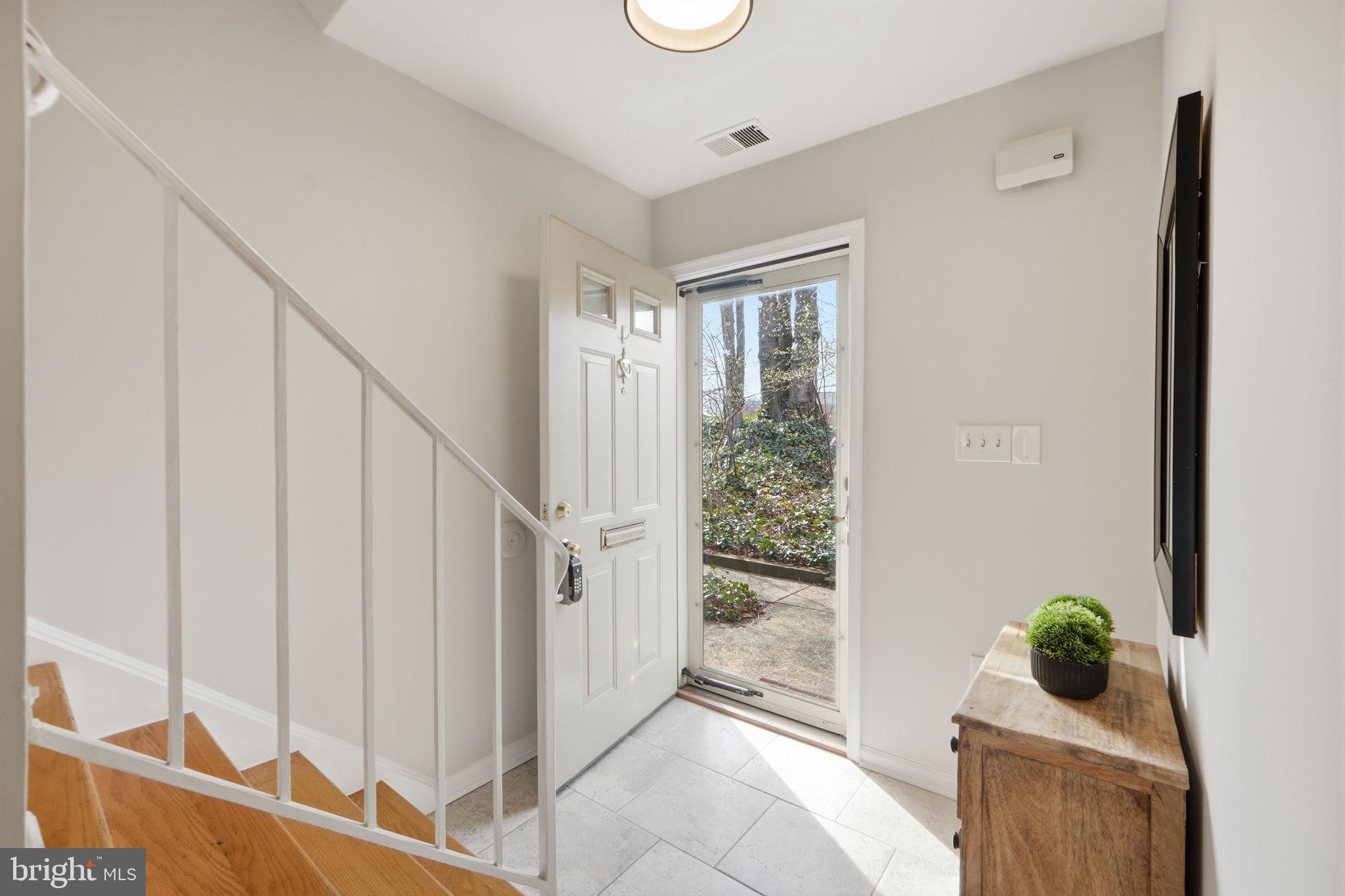 8230 Carrleigh Parkway, Unit 84 Springfield, VA 22152 - Photo 4 of 28 a room with stairs and a potted plant