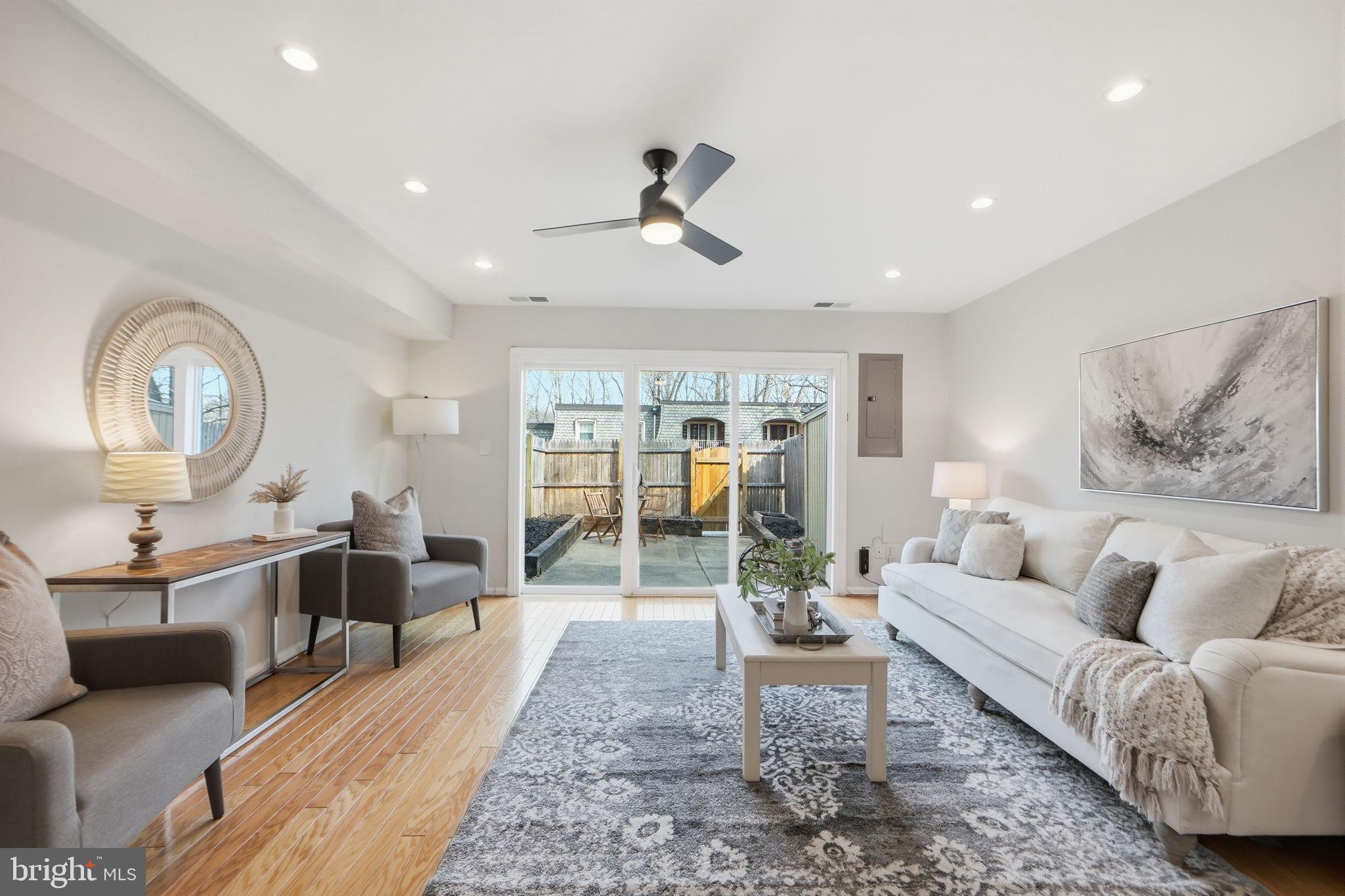 8230 Carrleigh Parkway, Unit 84 Springfield, VA 22152 - Photo 5 of 28 a living room with furniture a rug potted plant and a large window