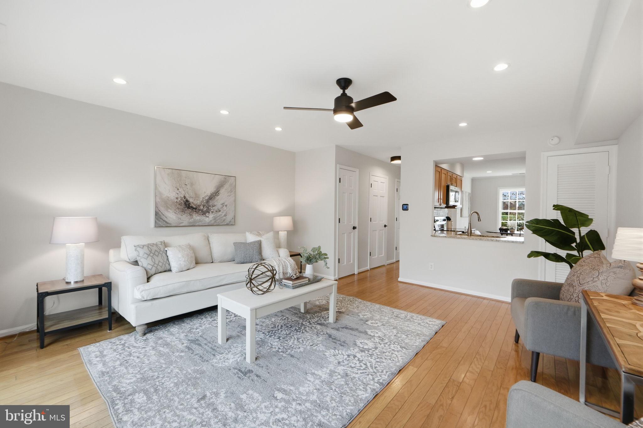 8230 Carrleigh Parkway, Unit 84 Springfield, VA 22152 - Photo 7 of 28 a living room with furniture and a rug