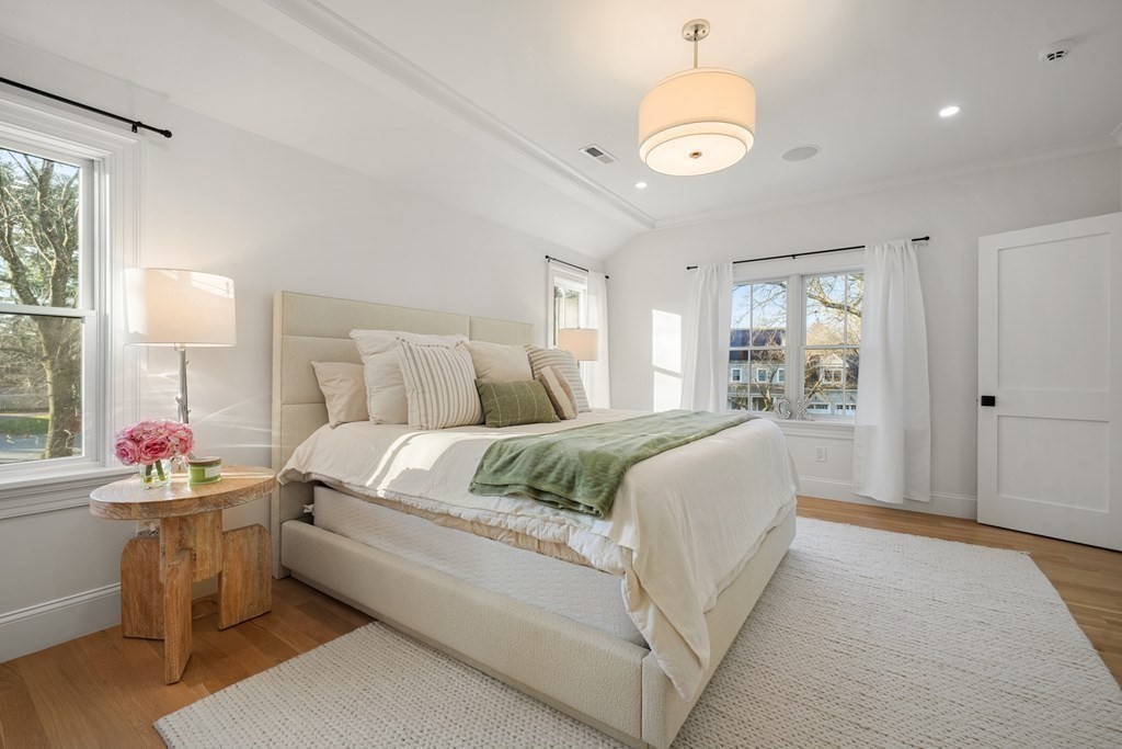 6 Juniper Place Lexington, MA 02420 - Photo 14 of 32 a spacious bedroom with a bed and a chandelier