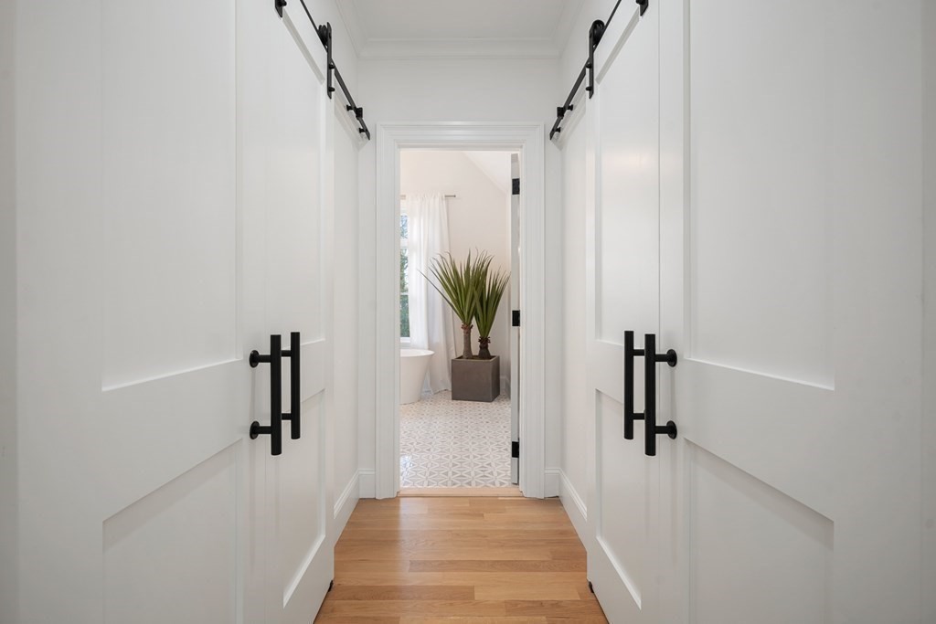 6 Juniper Place Lexington, MA 02420 - Photo 15 of 32 a hallway with a potted plant on a wall
