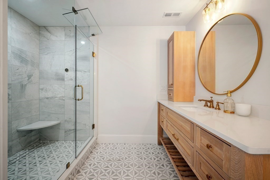 6 Juniper Place Lexington, MA 02420 - Photo 17 of 32 a bathroom with a double vanity sink mirror and shower