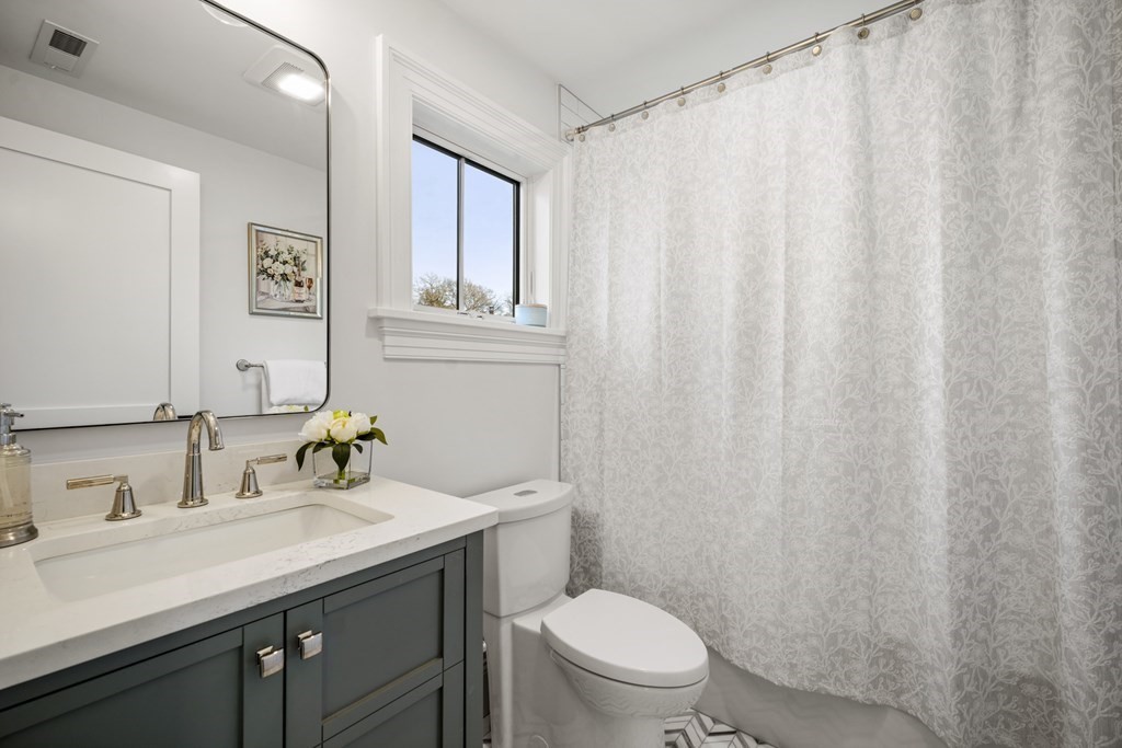 6 Juniper Place Lexington, MA 02420 - Photo 22 of 32 a bathroom with a sink a toilet and a mirror