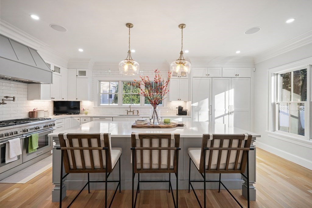 6 Juniper Place Lexington, MA 02420 - Photo 8 of 32 a kitchen with a dining table chairs and wooden floor