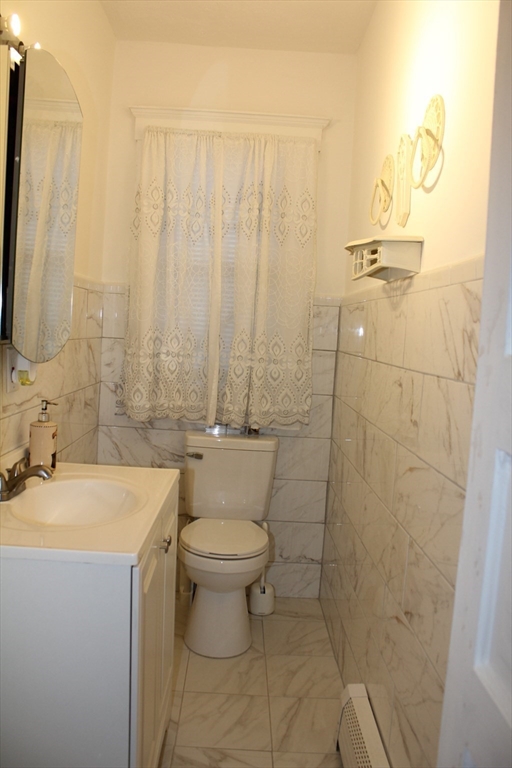 618 Harvard Street Boston, MA 02126 - Photo 13 of 42 a bathroom with a sink a toilet and shower