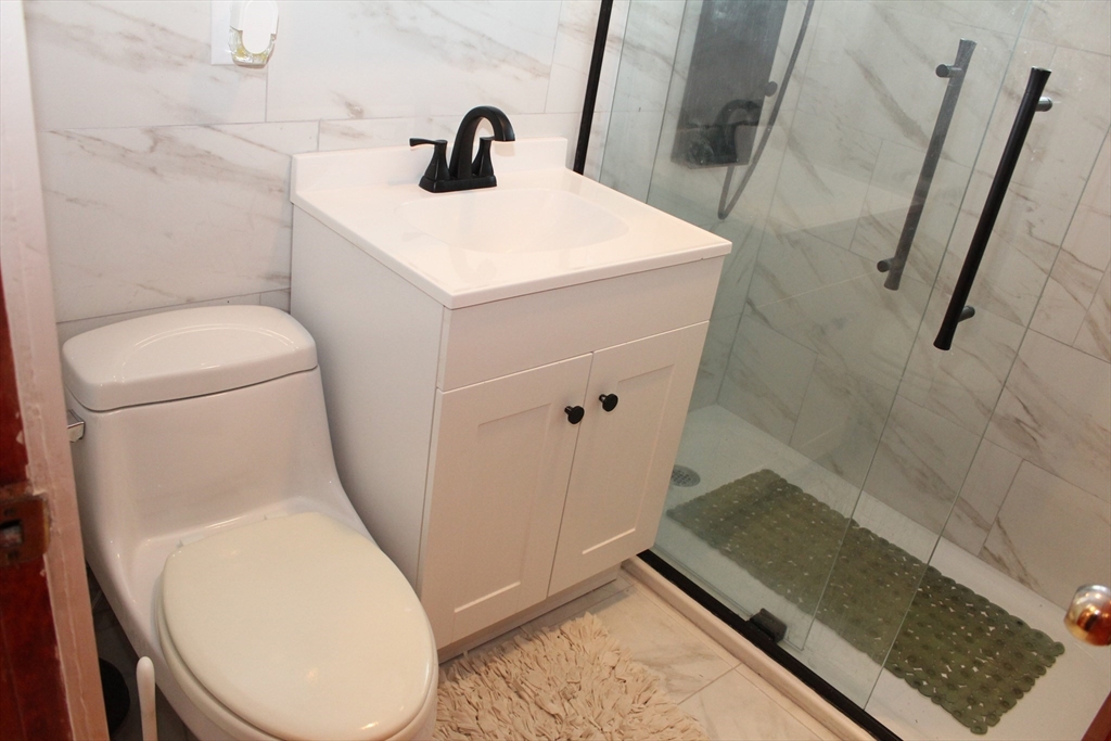 618 Harvard Street Boston, MA 02126 - Photo 32 of 42 a bathroom with a toilet and a sink